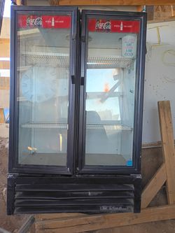 True Manufacturing Coca-Cola branded two-door commercial merchandising refrigerator.