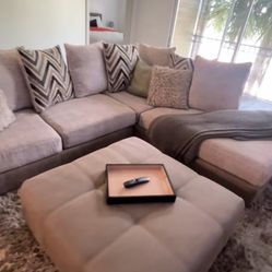 living room sectional with ottoman rug and pillows