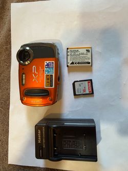 Waterproof Fujifilm FinePix XP50 14MP digital camera in orange. This bundle includes a Fujifilm NP-45A lithium-ion battery, a 16GB SanDisk Ultra SD ca