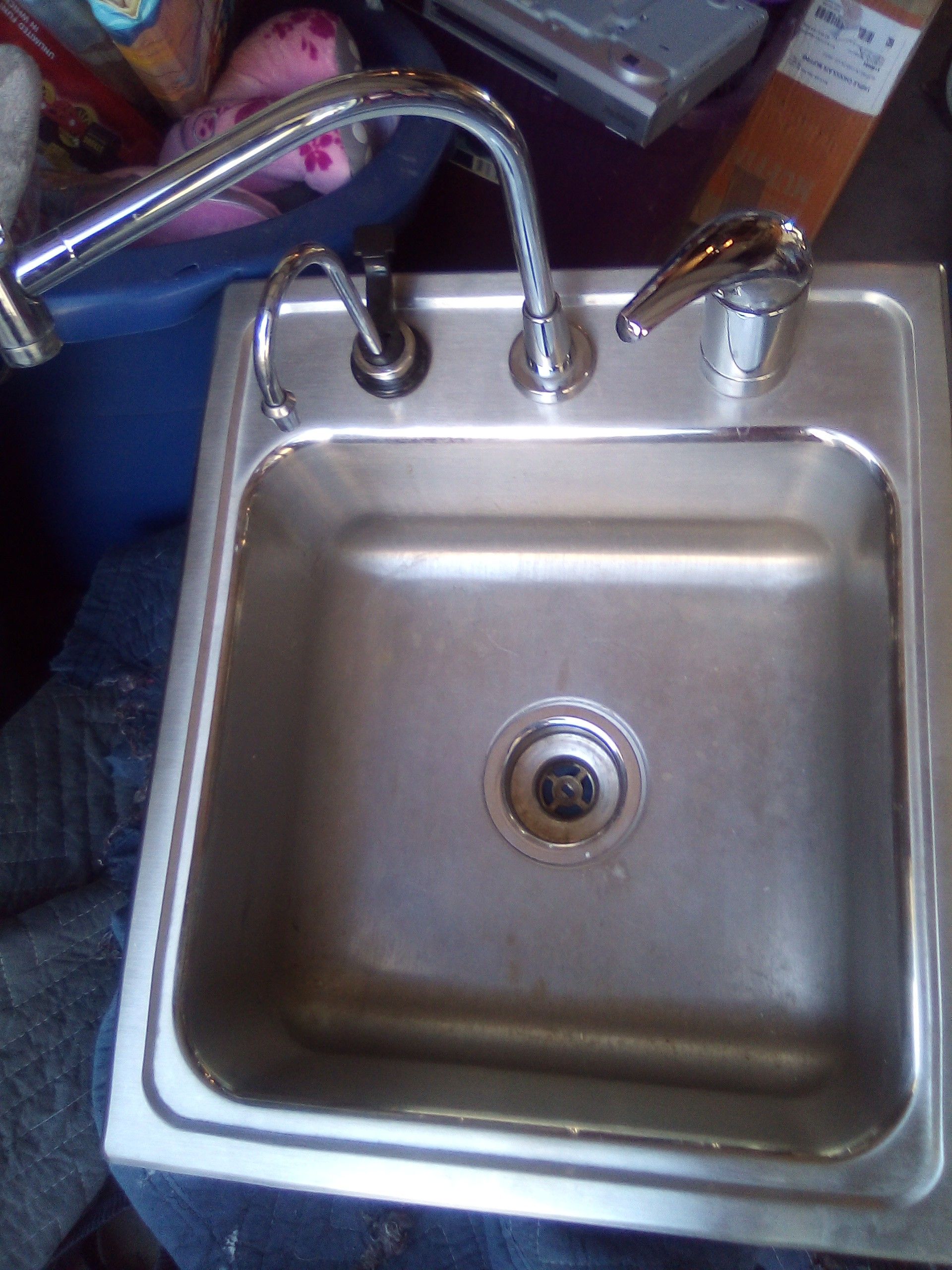 Stainless steel sink with water heater attachment