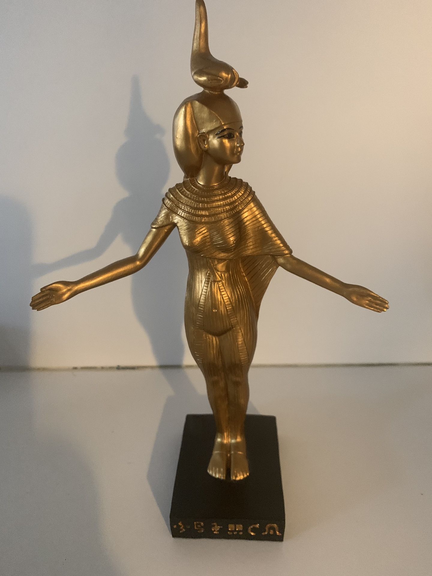 Egyptian goddess statue in gold and black