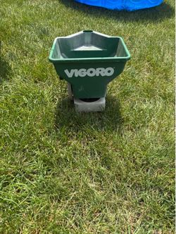 Hand held seed spreader