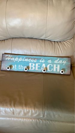 Sign with knobs for hats/jackets