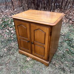 mid-century walnut open-shelf nightstand.