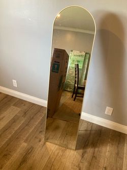 Gold framed arched floor mirror