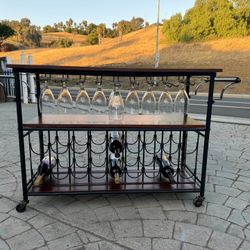 Wine table with wine glass shelving and wine bottle shelves