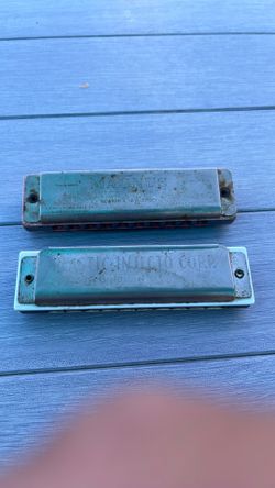 Two vintage harmonicas