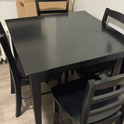 black wooden dining table set with 4 chairs