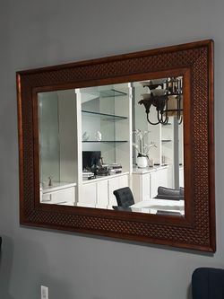 large decorative wall mirror with a carved wooden frame