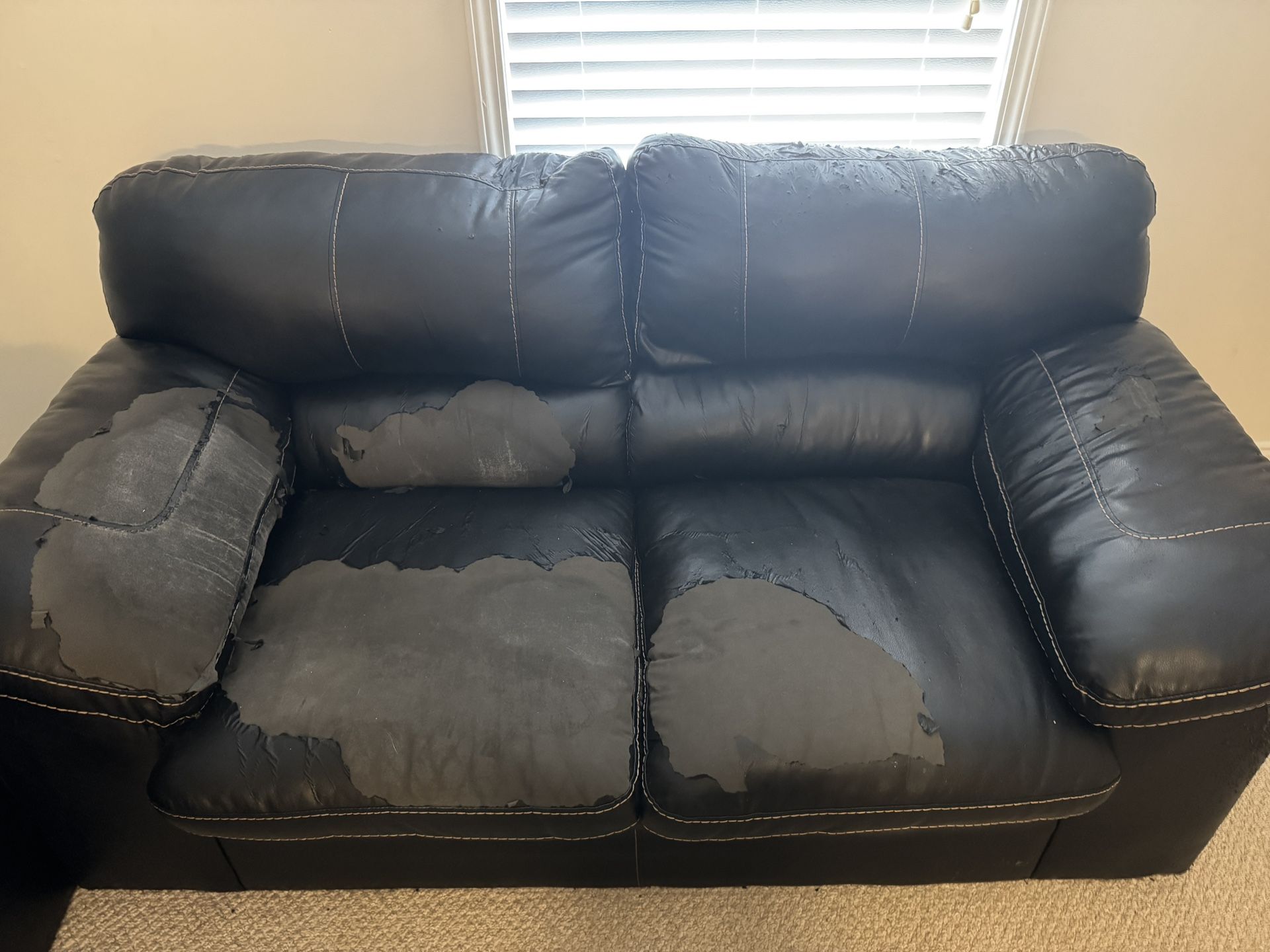 Well Loved Black Loveseat And Ottoman