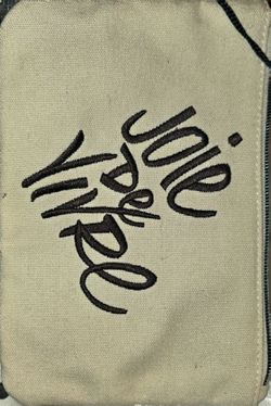 makeup bag with the tags joie de vivre