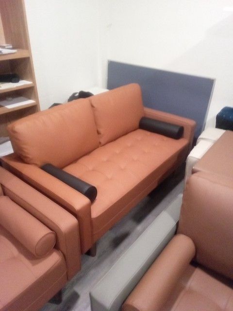 Tangerine Orange Leather Couch Black Pillow