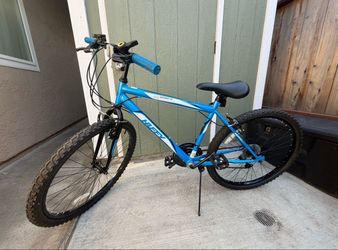 Blue Huffy bike 24” wheels