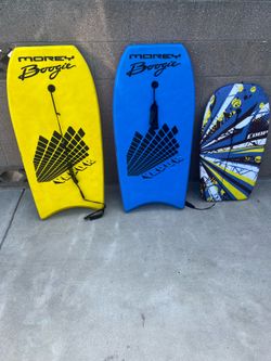 yellow Morey Boogie Valor, a blue Morey Boogie Valor, and a smaller patterned Coop bodyboard.