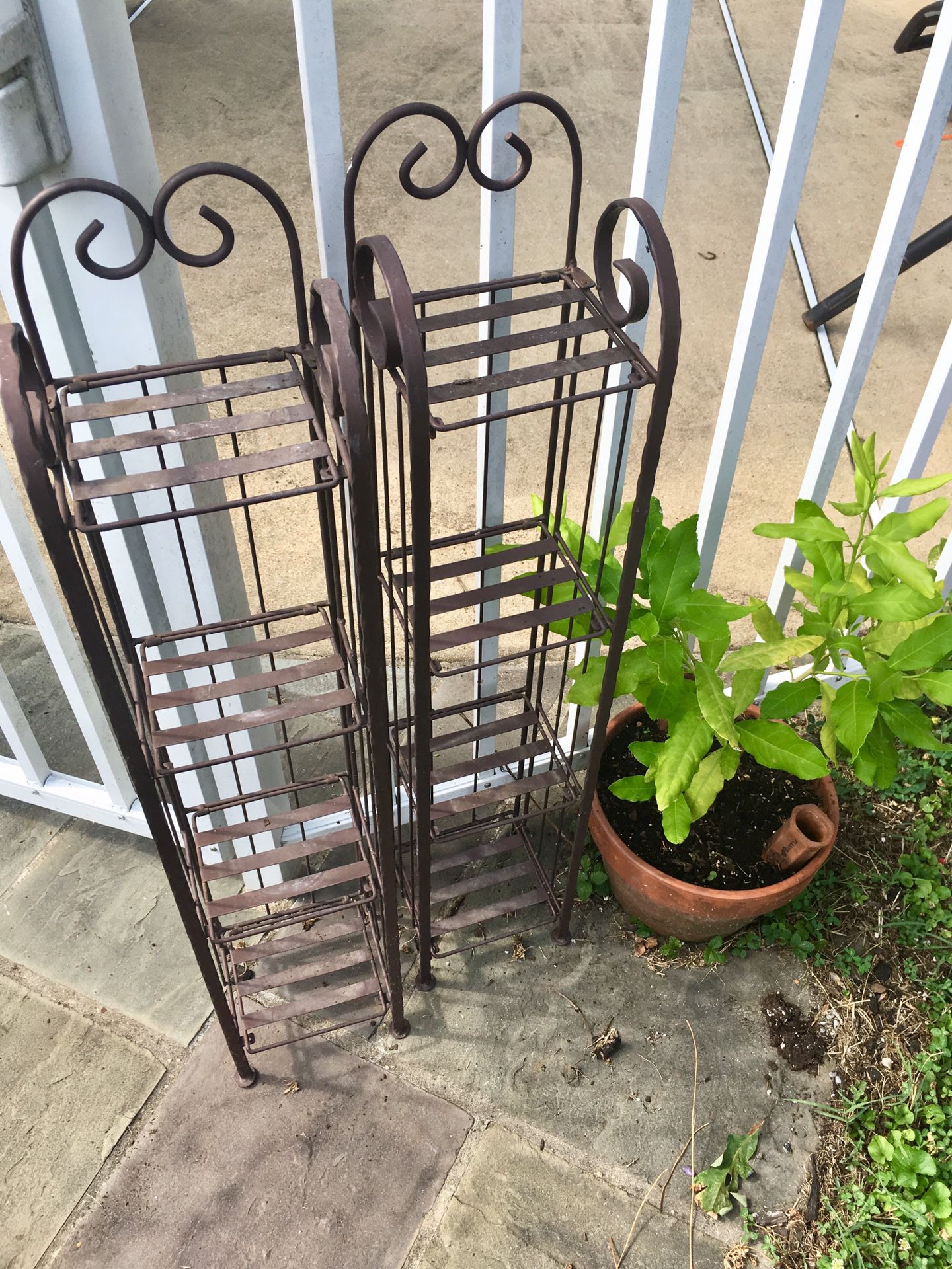 Two metal plant stands w/ 4 shelves. $15 each, or both for $25