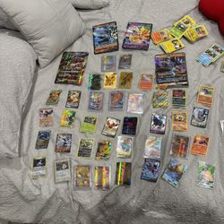 Pokémon cards with sleeve holder,tins,barcodes,metal pokeball, and coins