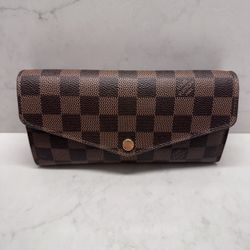 Authentic Louis Vuitton Sarah Wallet in Damier Ebene with Rose Ballerine interior.  