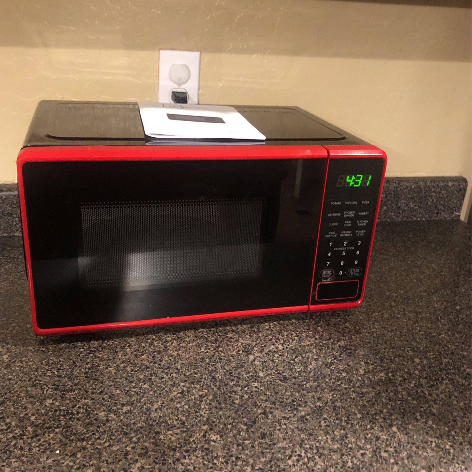 Mainstays 0.7 Cu ft Compact Countertop Microwave Oven, Red