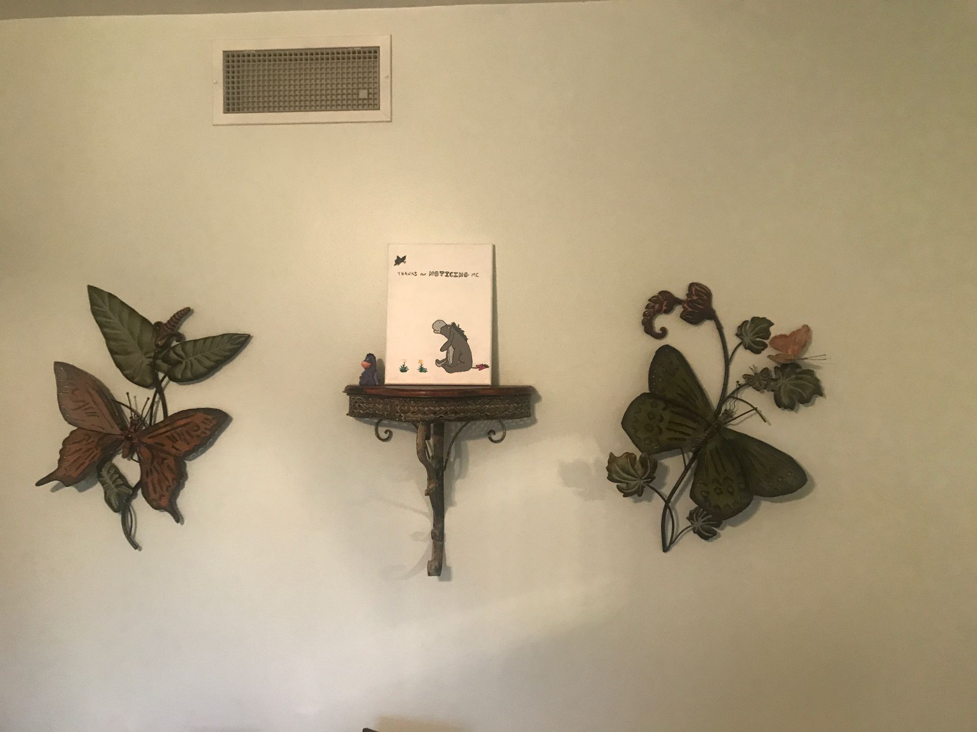 Metal butterflies and wooden top shelf