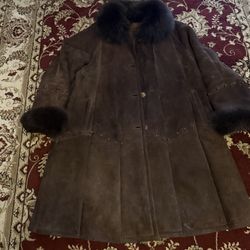 Natural sheepskin coat with sheep fur on the collar and sleeves, and natural squirrel fur trim. Very warm.