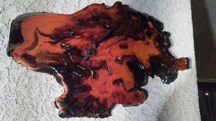 An antique red orange wood clock