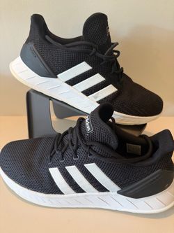 adidas Questar Flow NXT in the "Core Black/Cloud White" colorway.