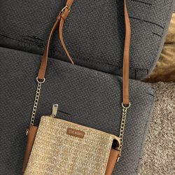 Steve Madden faux leather trim and a woven raffia-style front panel purse