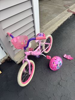 Girl bike with training wheels and helmet
