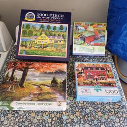 Four 1000 piece jigsaw puzzles 