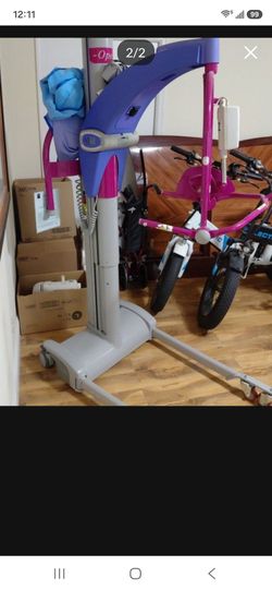 Electric patient lift with charger and slings