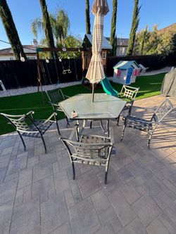 Outdoor patio table, chairs and umbrella