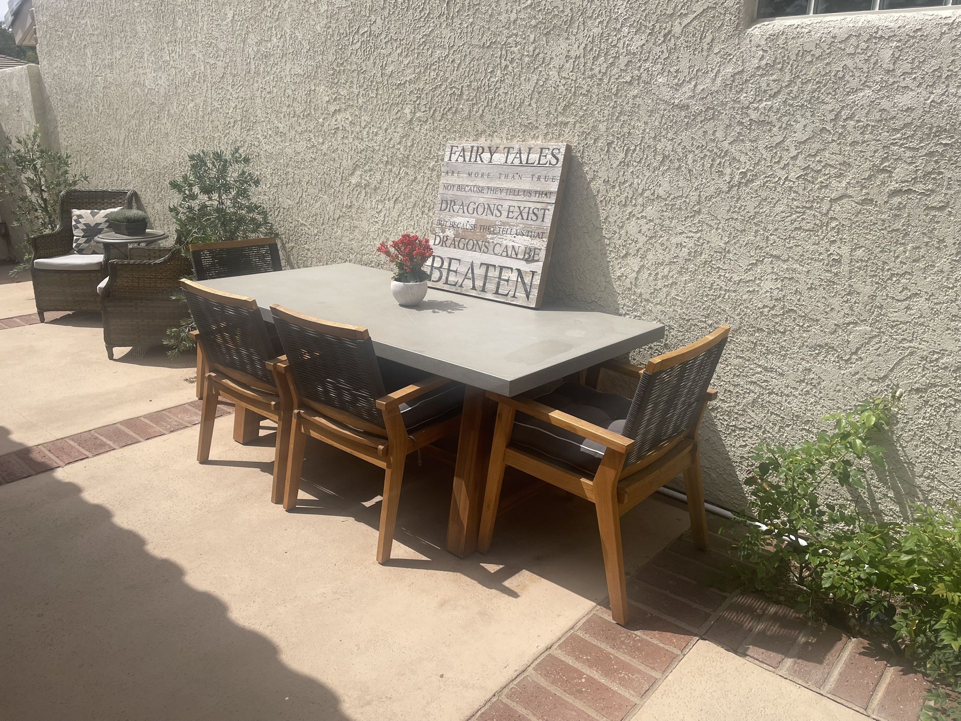 6 Woven Chairs And Stone Table With Wood Legs