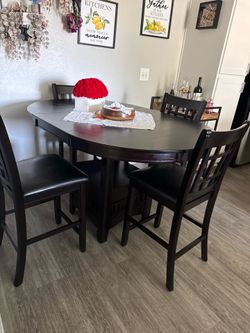 Dark brown dining table with chairs