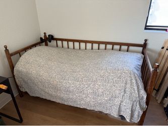 Vintage style wooden bed frame with metal spring base.