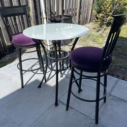 Two Metal Swivel (Bar Stools 29”H To Seat Purple Fabric) And (Table 31”D X 351/2”H With White Glass) In Good Condition $60 Firm On Price