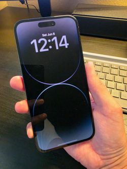 iPhone 14 Pro Max with case and chargers