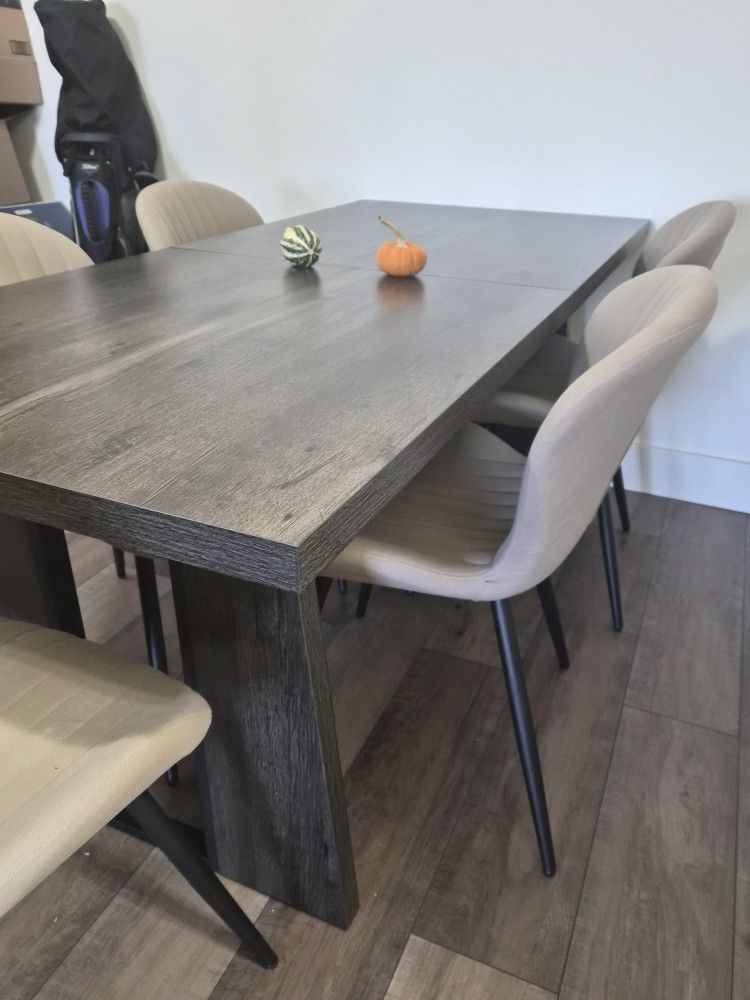 Modern dark wood dining table set — includes chairs.