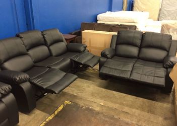 Black leather fully reclining couch and love seat