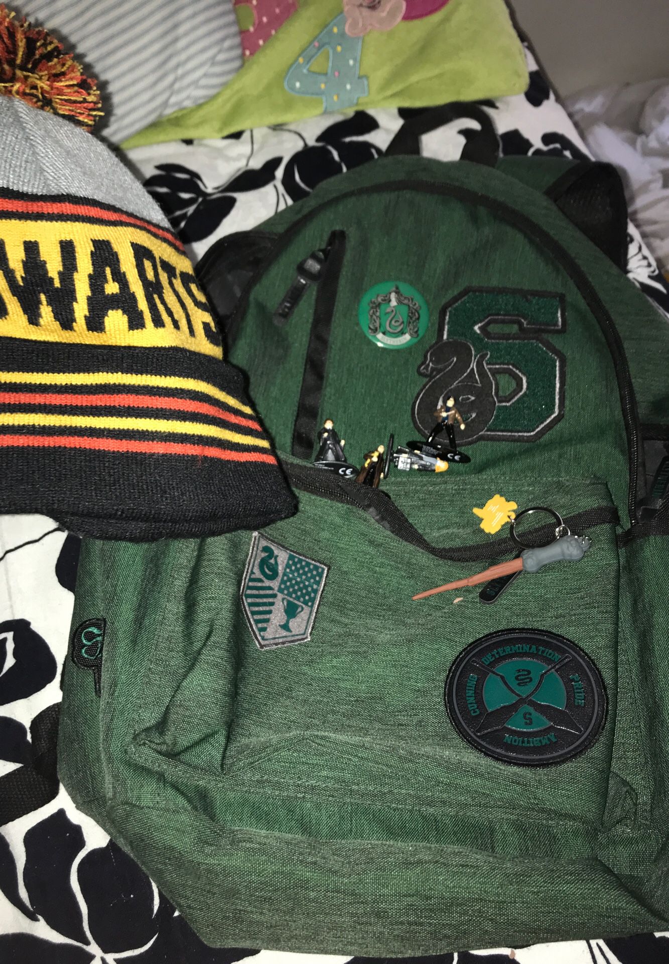 Slytherin Harry Potter back pack from the Harry Potter collectible site retail price 50 with hog warts hat and some Harry Potter toys