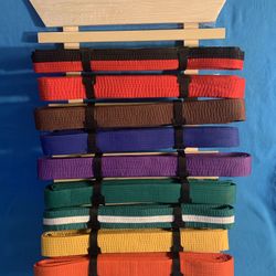 Wall-mounted stand for martial arts belts. 