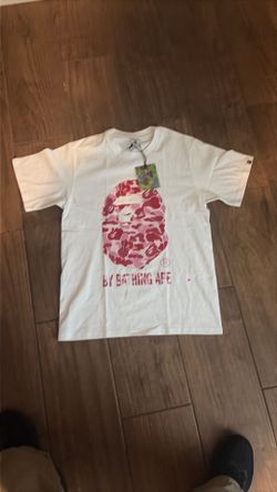 A pink and white bathe and ape shirt