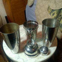 Stainless steel bar mixing containers.