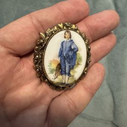 Antique brooch with a painted portrait in a decorative frame