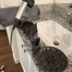 Dyson Supersonic hair dryer with stand, bag, and attachments