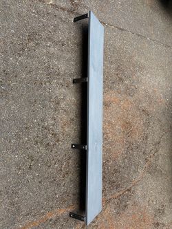 Four gray stained wooden shelves with black brackets