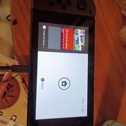 Nintendo Switch With Charging Port For TV And Also Large Joystick Plus Extra Joysticks To Go On The Side Of The Game With Four Games And A Couple Down