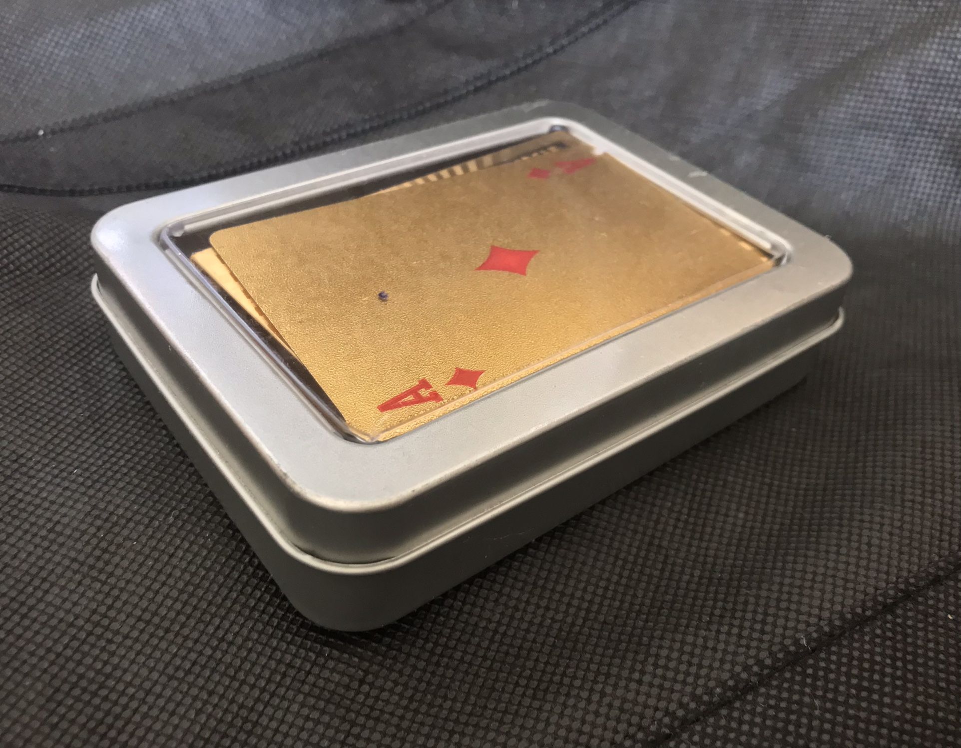 gold colored playing cards with $ theme