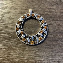 Silver pendant with orange gems