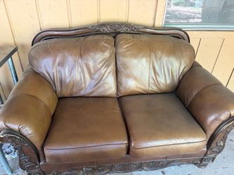 Brown Leather Loveseat with Carved Wood Frame