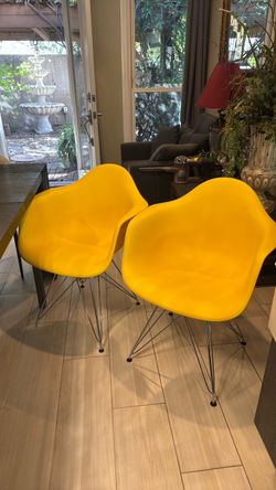 2 plastic yellow chairs
